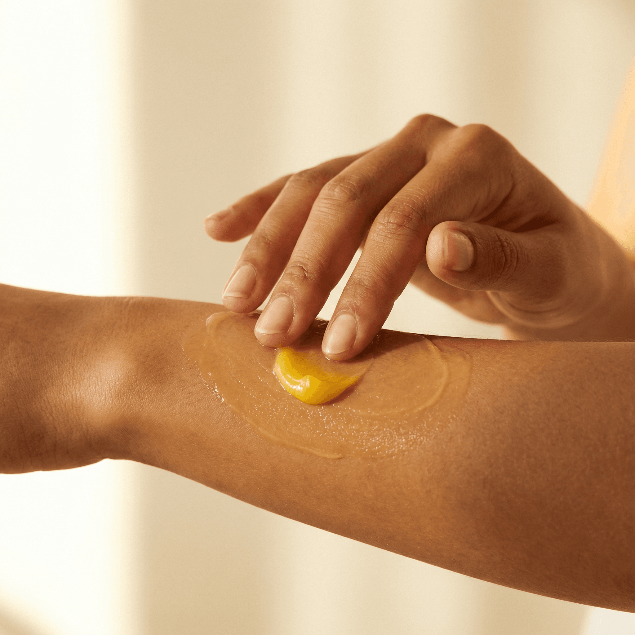 BUTTR balm being applied to the back of a hand
